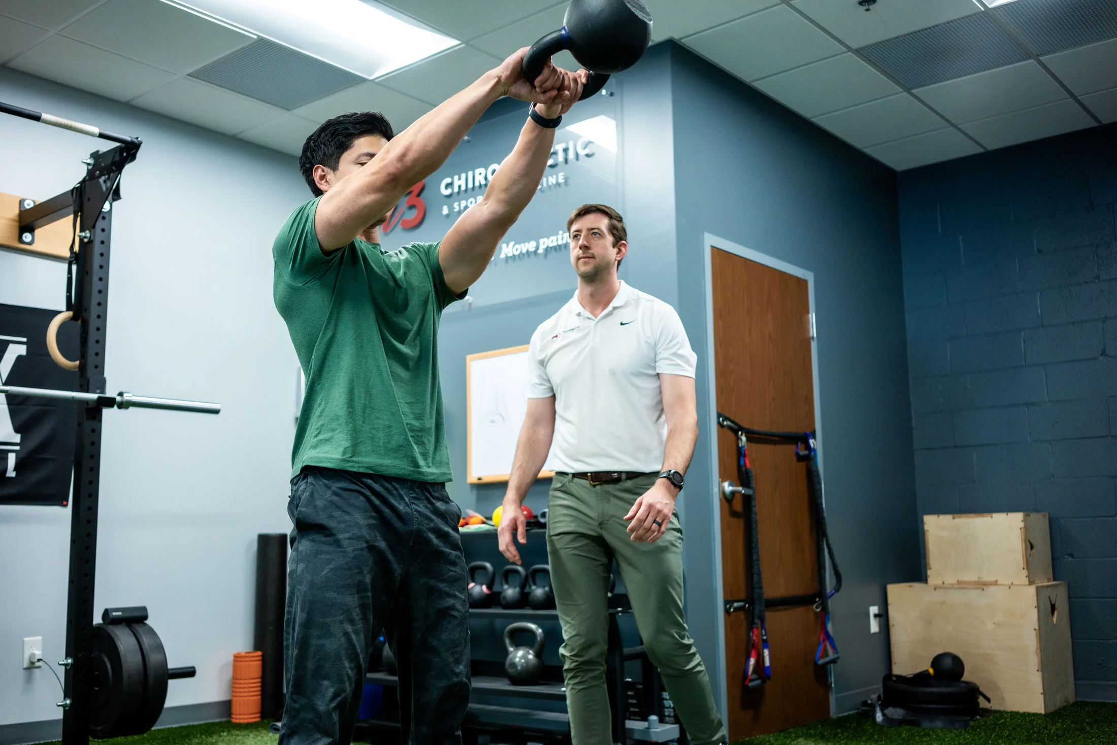 A Foundation for Comprehensive Care Dr. Drew working with patient lifting a kettle bell