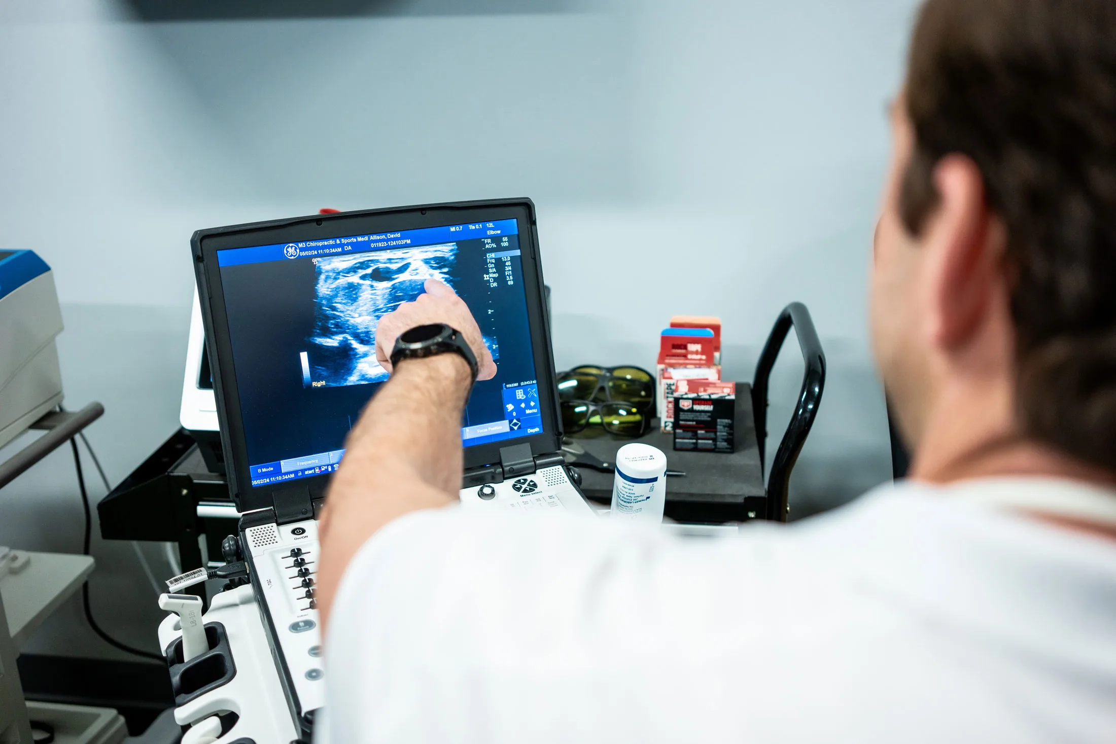 Immediate Results, Informed Decisions Dr. Drew pointing at a Diagnostic Ultrasound